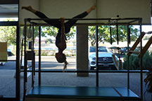 pilates austin hanging splits on the Cadillac