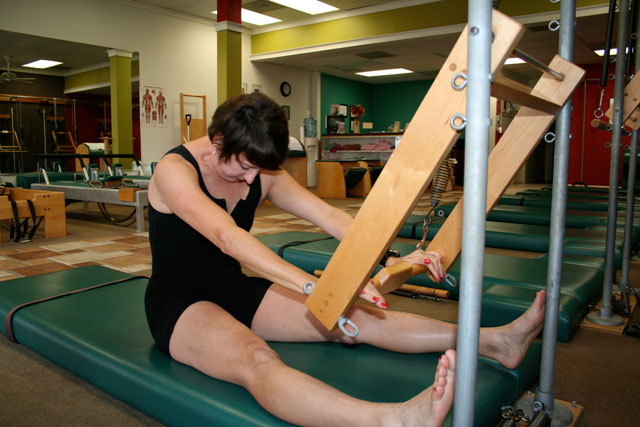 Pilates push through technique on the tower mat