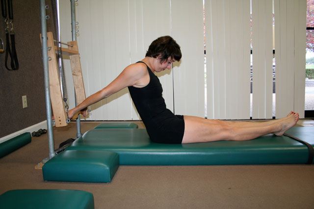 Pilates reverse push through technique on the tower mat