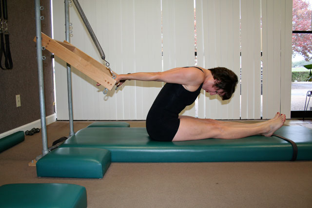 Pilates reverse push through technique on the tower mat