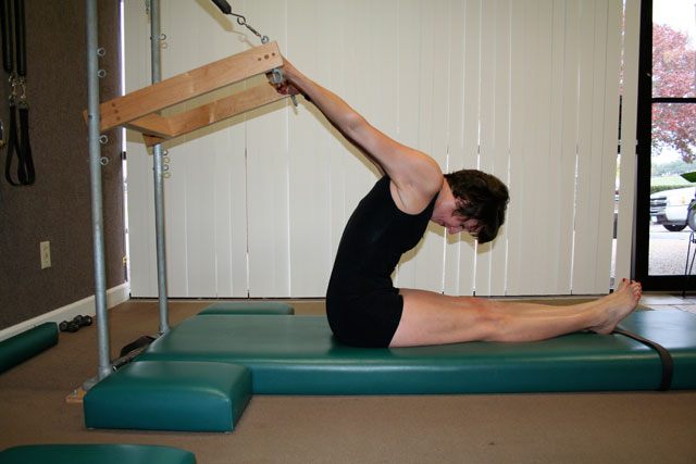 Pilates reverse push through technique on the tower mat