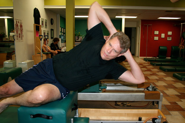 Pilates side situps technique on the reformer